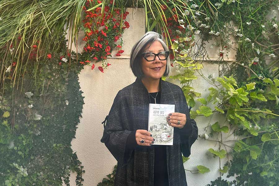 ניצה אבירם מחזיקה את הספר שלה לכתוב מהבטן