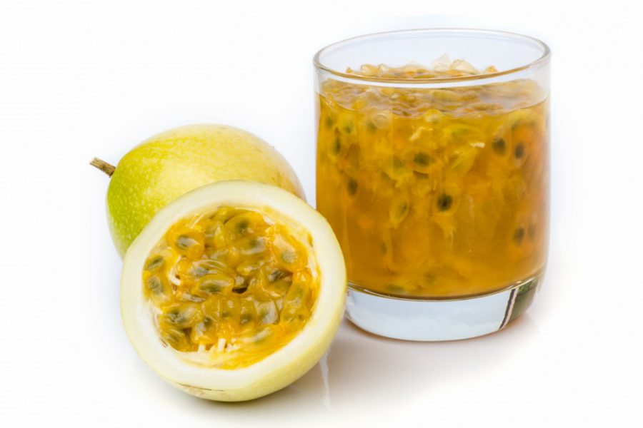 Ripe passion fruit with passion fruit juice isolated on white background.